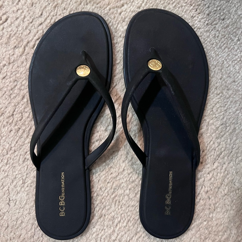 BCBGeneration Black Thong Sandals with Gold Logo Accent